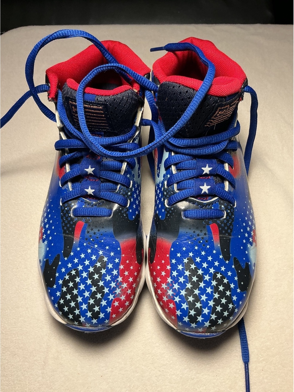 Under Armour kids football cleats red white blue star print